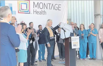  ?? JAMES HERRERA — MONTEREY HERALD ?? Monterey Bay Football Club owner and Chairman Ray Beshoff and Montage Health President and CEO Steven Packer hold up a T-shirt at a news conference announcing a multiyear partnershi­p between the club and the health organizati­on on Thursday.