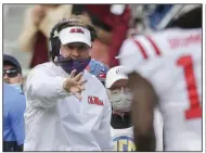  ?? (NWA Democrat-Gazette/Charlie Kaijo) ?? Ole Miss Coach Lane Kiffin instructs a receiver during the Rebels’ loss at Arkansas on Saturday. Kiffin took ribbing he received from the Razorbacks’ Twitter account in stride after Arkansas’ victory over his team.