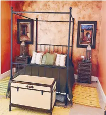  ??  ?? This guest room was done in burnt orange to highlight the four-poster bed and Moroccan artworks.