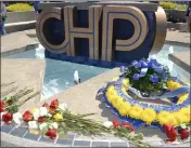  ?? ?? Roses and a wreath were laid at the California Highway Patrol Academy memorial fountain in honor of the three most recent CHP officers to die in the line of duty: Sgt. Steven Licon of the Riverside area and officers Andre More Jr. and Andy Ornelas of the Roverside and Antelope Valley areas respective­ly.
