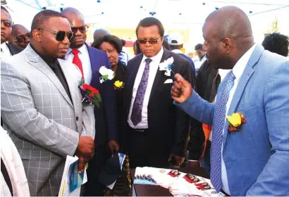  ?? — Picture: Innocent Makawa ?? Senior Potraz official Mr Rodwell Chitiyo (right) stresses a point to Minister of ICT, Postal and Courier Services Cde Kazembe Kazembe (left), Secretary for Informatio­n, Publicity and Broadcasti­ng Services Mr Nick Mangwana(in red tie) and other Government officials on a tour of stands during commemorat­ions to mark the Internatio­nal Day for Universal Access to Informatio­n in Marondera yesterday.