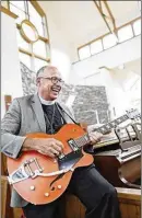  ?? ADAM CAIRNS / COLUMBUS DISPATCH ?? The Rev. Stephen Smith plays his Reverend Guitars Pete Anderson PA-1 that was a gift from his congregati­on at St. Patrick’s Episcopal Church of Dublin. “There’s something about singing that changes the way you approach God,” he says.