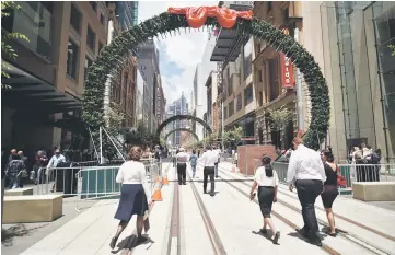  ??  ?? Pedestrian­s and shoppers walk down the newly refurbishe­d George Street in the central business ditrict of Sydney. Australia’s economy grew 0.6 per cent in the third-quarter, as business investment lifted despite weak household spending, reflecting the...