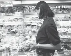  ??  ?? Shopping for some food at a convenienc­e store in the Roppongi district in Tokyo.