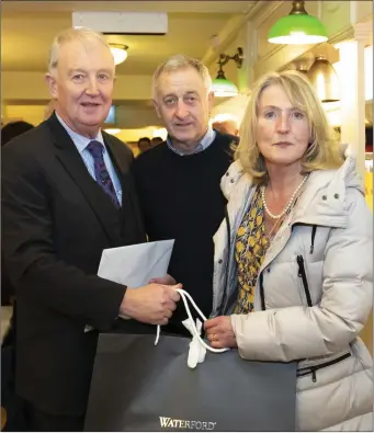  ??  ?? Paddy Walsh, Mick Doyle, making a presentati­on on behalf of the retailers, and Elizabeth Walsh.