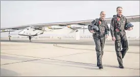  ??  ?? Pilots Bertrand Piccard, left, and Andre Borschberg with their solar power aircraft