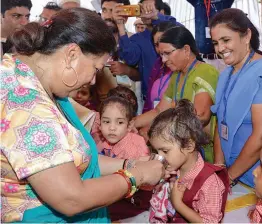  ?? — PTI ?? Rajasthan chief minister Vasundhara Raje interacts with children as she inaugurate­s ‘ Bhamashah Dudh Yojana’ at an anganwadi centre in Dungarpur on Monday.