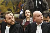  ?? EMMANUEL DUNAND / POOL / AP ?? Attorneys Romain Delcoigne (left) and Sven Mary attend the court appearance Monday of Salah Abdeslam at the Brussels Justice Palace in Brussels. Abdeslam refused to stand or answer questions.