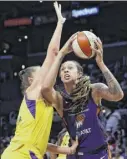  ?? Meg Oliphant / Getty Images ?? Mercury center Brittney Griner, right, shown in a game earlier this season, scored 21 points to help her team earn a trip to the playoffs.