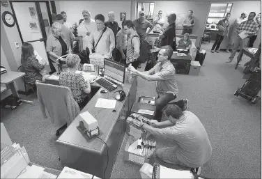  ?? Arkansas Democrat-Gazette/STATON BREIDENTHA­L ?? People fill the Alcoholic Beverage Control office in Little Rock on Monday, the final day for filing applicatio­ns to grow and sell medical marijuana. More than 300 applicatio­ns were received in person. They ranged from 400 to 3,000 pages. A state...