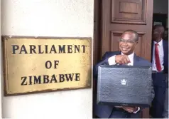  ?? ?? Minister Ncube holds his briefcase as he prepares to present the 2022 National Budget in Parliament on Thursday