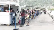  ??  ?? Visitors line up at the ticket booth before boarding the ship in Kingston, Jamaica.