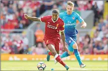  ??  ?? Liverpool’s Dutch midfielder Georginio Wijnaldum (left), vies with Arsenal’s Welsh midfielder Aaron Ramsey during the English Premier League football match between Liverpool and Arsenal in Liverpool, northwest England
on Aug 27. (AFP)