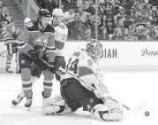  ?? THE CANADIAN PRESS VIA AP Jason Franson ?? Panthers’ goalie James Reimer makes the stop as the Oilers’ Connor McDavid looks for the rebound.