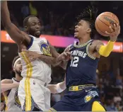  ?? BRANDON DILL — THE ASSOCIATED PRESS ?? Grizzlies guard Ja Morant (12) shoots against Warriors forward Draymond Green (23) during the second half of Game 2of a Western Conference semifinal on Tuesday in Memphis, Tenn.