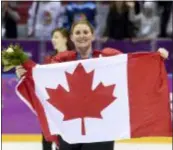  ?? PAUL CHIASSON — THE ASSOCIATED PRESS FILE ?? Canada’s Hayley Wickenheis­er celebrates with the Canadian flag after beating the USA at the 2014 Winter Olympics in Sochi, Russia.