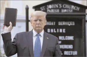  ?? The Associated Press ?? President Donald Trump holds a Bible as he visits outside St. John’s Church across Lafayette Park from the White House Monday in Washington. Part of the church was set on fire during protests on Sunday night.