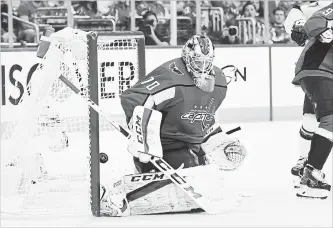  ?? JONATHAN NEWTON THE WASHINGTON POST ?? A puck gets by Capitals goaltender Braden Holtby in the second period of Game 3 on Tuesday night against the Tampa Bay Lightning in Washington.