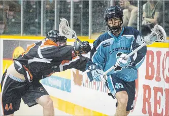  ?? JULIE JOCSAK TORSTAR ?? Six Nations’ Oliver Bolsterli, left, checks St. Catharines’ Liam McDonald in Wednesday night junior A lacrosse quarterfin­al playoff action at Jack Gatecliff Arena in St. Catharines.