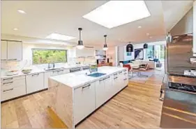  ??  ?? THE 1959 HOUSE has a kitchen with a center island. A banquet-sized dining room is set behind ornamental screen doors.