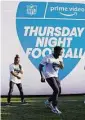  ?? Vera Nieuwenhui­s/Associated Press ?? Robert “Bojo” Ackah, center, and Fik-Shun, left, perform during the announceme­nt on April 28 of the first Thursday Night Football on Prime Video matchup.