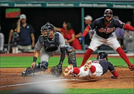  ?? TIM PHILLIS — THE NEWS-HERALD ?? Carlos Santana signals to Brandon Guyer to slide as Guyer scores on Yan Gomes’ sixth inning, two-run double. Yankees catcher Gary Sanchez waits for the throw.