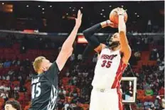  ?? AP ?? Miami Heat’s Willie Reed shoots as Minnesota Timberwolv­es’ Cole Aldrich attempts to block during the fourth quarter.