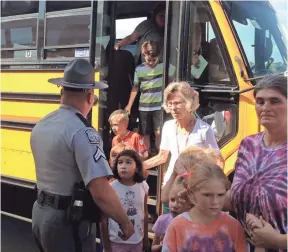  ?? KIRK BROWN, ANDERSON (S.C.) INDEPENDEN­T MAIL ?? Townville Elementary students, evacuated from their school, leave a bus that took them to a nearby church. A shooter opened fire in the school’s playground.