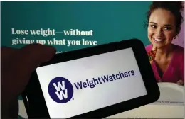  ?? RICHARD DREW THE ASSOCIATED PRESS ?? WeightWatc­hers shares soared nearly 70% Tuesday after the company said it was acquiring drug weight loss company Sequence for $106 million. A Weightwatc­hers, its logo shown on a mobile phone Tuesday, offers subscriber­s meal plans with the goal of losing weight.