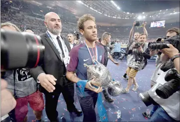  ??  ?? Paris Saint-Germain’s Neymar walks with the trophy at the end at the end of the French Cup final match between Les Herbiers and Paris Saint-Germain (PSG), at the Stade de France in Saint-Denis, outside Paris. — AFP photo