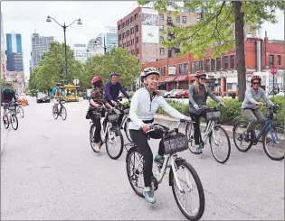  ?? STEVE MACNAULL PHOTO ?? Hike group cycles through Fulton Market District, the former meatpackin­g district turned restaurant and tech hotspot.