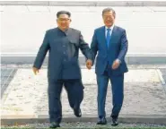  ?? KOREA BROADCASTI­NG SYSTEM VIA AP ?? North Korean leader Kim Jong Un, left, crosses the border into South Korea, along with South Korean President Moon Jae-in, for their historic face-to-face talks, in Panmunjom.