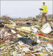  ?? BUTCH DILL / ASSOCIATED PRESS ?? Bob Wright looks for personal belongings Wednesday after a suspected tornado ripped through the town of Rosalie, Ala., the previous night, killing three of his brother’s family members.