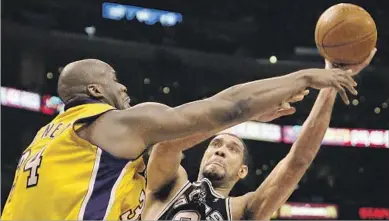  ?? Kevork Djansezian Associated Press ?? SHAQUILLE O’NEAL, who nicknamed Tim Duncan the Big Fundamenta­l, fouls Duncan during the 2004 playoffs.