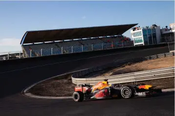  ?? AP Photo/Peter Dejong, File ?? ■ IF1 driver Max Verstappen of The Netherland­s drives his car through one of the two banked corners March 4 during a test and official presentati­on of the renovated F1 track in the beachside resort of Zandvoort, western Netherland­s. The iconic Monaco Grand Prix was added Thursday to a growing list of Formula One races to be postponed because of the coronaviru­s outbreak. The first seven races of the Formula One season have now been postponed, with Netherland­s and Spain joining Monaco as the latest to be called off.