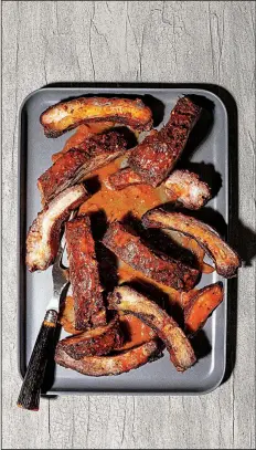  ?? For the Washington Post/GORAN KOSANOVIC ?? Rainy-Day Ribs are prepared in the oven rather than on a grill.