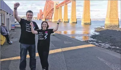  ??  ?? Mary MacDougall and husband, Douglas, celebrate after her successful charity abseil from the Forth Rail Bridge.