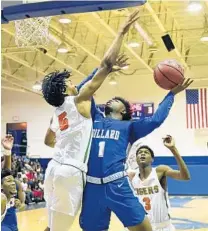  ??  ?? Dillard’s Deshawn Bartley tries to score on Ely’s Aderes Stanton-McCray during the first half of their BCAA Big 8 boys basketball finals game Saturday at Fort Lauderdale High.