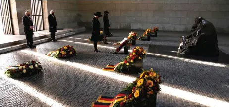  ?? — AFP photo ?? (From left) Charles, Steinmeier and their wives Camila and Elke Buedenbend­er pay their respect during a wreath laying ceremony on national Memorial Day at the Neue Wache in Berlin.