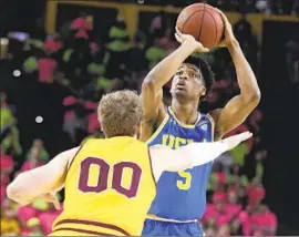  ?? Darryl Webb Associated Press ?? CHRIS SMITH, right, and UCLA take on Mickey Mitchell and Pac-12 Conference leader Arizona State on Thursday night at Pauley Pavilion.