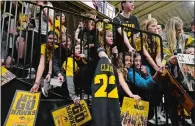  ?? CHARLIE NEIBERGALL/AP FILE PHOTO ?? Fans wait to get an autograph from Iowa guard Caitlin Clark after a women’s college basketball game Feb. 8 in Iowa City, Iowa.