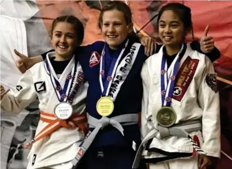  ?? Photo:
Contribute­d ?? NATIONAL SUCCESS: TACAPS student Lily Baguley (left) pictured with her silver medal at the Brazilian Jiu Jitsu Australian Championsh­ips.