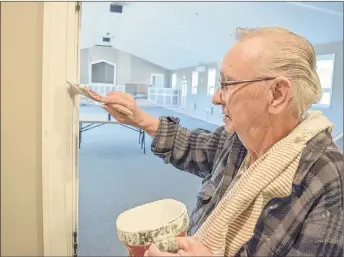  ?? KENT MACDONALD/SPECIAL TO THE NEWS ?? Ellery Cameron puts some final touches of paint on trim at Bethel Baptist Church in Westville. Volunteers have helped build a new 4,800-square-foot addition.