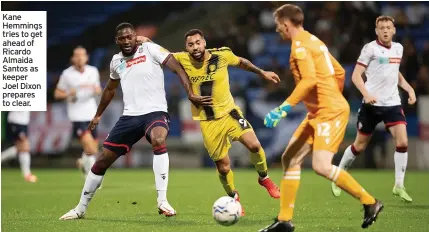  ??  ?? Kane Hemmings tries to get ahead of Ricardo Almaida Santos as keeper Joel Dixon prepares to clear.