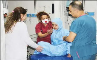  ?? (AP) ?? In this photo taken on April 4, and made available on April 5, Turkish medics check a victim of alleged chemical weapons attack in Syrian city of Idlib, at a local hospital in Reyhanli, Hatay, Turkey. A suspected chemical attack in a town in Syria’s...