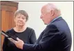  ?? Jeremy Stewart ?? Rockmart Mayor Sherman Ross (right) reads a congratula­tory statement from Parker Meggitt to Cathy Matthews recognizin­g her being named the 2022 Polk County Citizen of the Year at the Rockmart City Council meeting on Dec. 13, 2022.