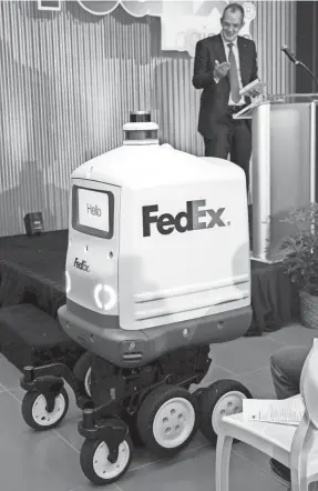  ?? CHRISTINE TANNOUS/THE COMMERCIAL APPEAL ?? A Fedex robot, called Roxo, rolls out during the grand opening for the new Fedex Logistics headquarte­rs April 5 in Memphis. Roxo will be used to make same day deliveries in short distances.