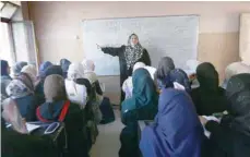  ?? — AFP ?? Girls attend a class at a school in west Mosul.