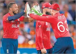  ?? ?? Chris Jordan (left) is congratula­ted by skipper Jos Butler after taking the wicket of India’s Virat Kohli in the semi-final