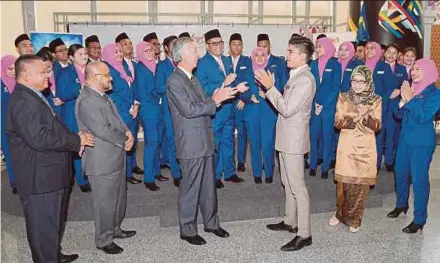  ?? BERNAMA PIC ?? Youth and Sports Minister Syed Saddiq Syed Abdul Rahman (third from right), Japanese ambassador Dr Makio Miyagawa (third from left) and Youth and Sports director- general Datuk Hatipah Ibrahim (second from right) with the Malaysian contingent in Putrajaya yesterday.